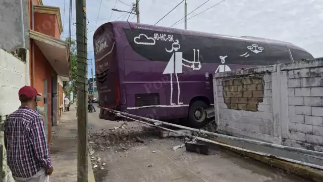 Vecinos viven minutos de tensión al derrumbarse barda por autobús de ADO