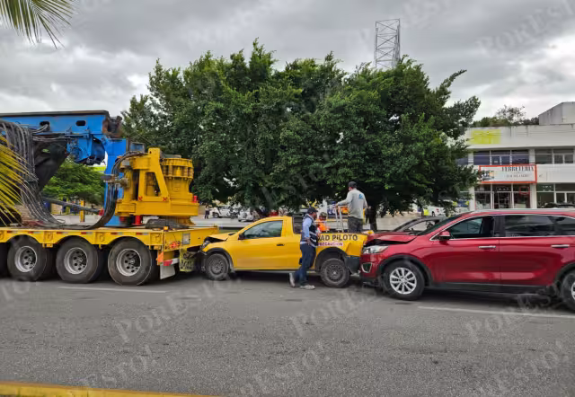 La camioneta de color amarillo terminó prensada entre el vehículo que provocó la colisión y el camión que resguardaba