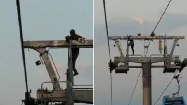 El hombre recorre la parte más alta de la estructura metálica.