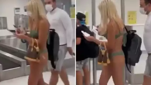 La joven caminaba tranquilamente por el aeropuerto en traje de baño
