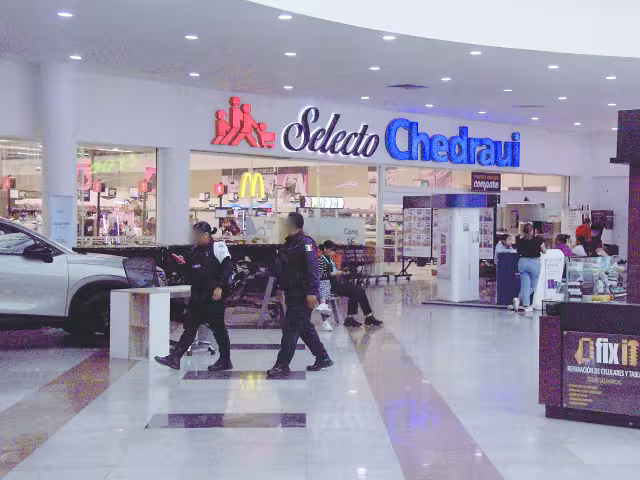 Elementos municipales armados recorren los pasillos, luego de que se registró una ejecución en el estacionamiento subterráneo y un intento de asalto