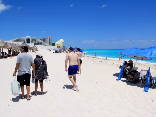 Turistas extranjeros aprovecharon las condiciones del día para caminar por la arena, mientras los nacionales llevaban alimentos y sus aguas para hidratarse.
