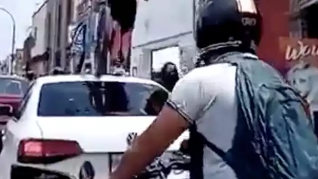 Este es el momento en que la ciclista pasa por encima de un auto estacionado en plena ciclovía