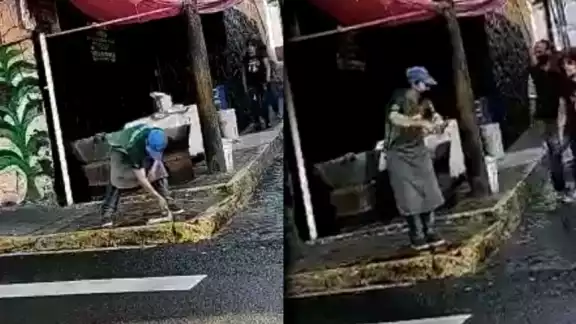 Imagen del trabajador lavando el trapo en la calle Imagen del trabajador lavando el trapo en la calle