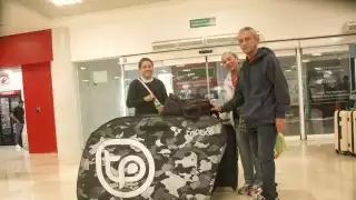 Con su enorme maleta, en donde lleva su pesada bicicleta, la colombiana Erika visitó Quintana Roo en compañía de sus padres