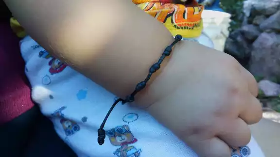 Es una tradición de Día de Muertos elaborar pulseras de hilo negro para proteger a los infantes Es una tradición de Día de Muertos elaborar pulseras de hilo negro para proteger a los infantes