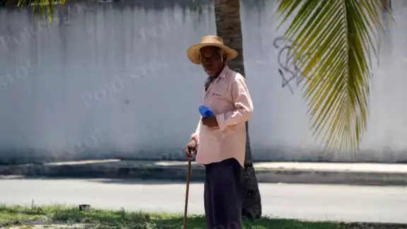 Pese al dolor y los rayos del sol, el hombre no se rinde para obtener algunas monedas Pese al dolor y los rayos del sol, el hombre no se rinde para obtener algunas monedas