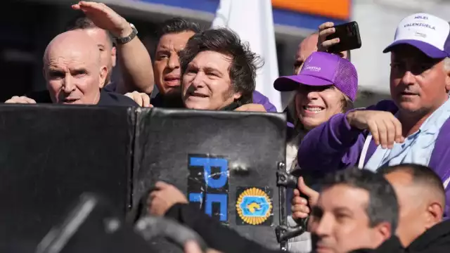 Ante la agresión, efectivos policiales usaron escudos para proteger al presidente, quien fue trasladado a un vehículo blindado