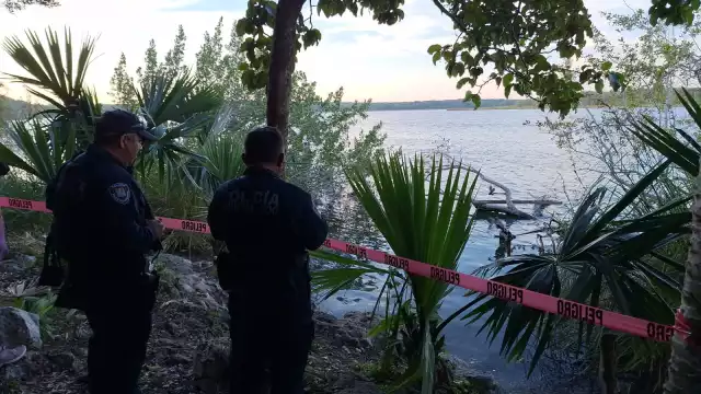 Oficiales colocaron la cinta de seguridad mientras esperaban a buzos para la recuperación del cuerpo del occiso.