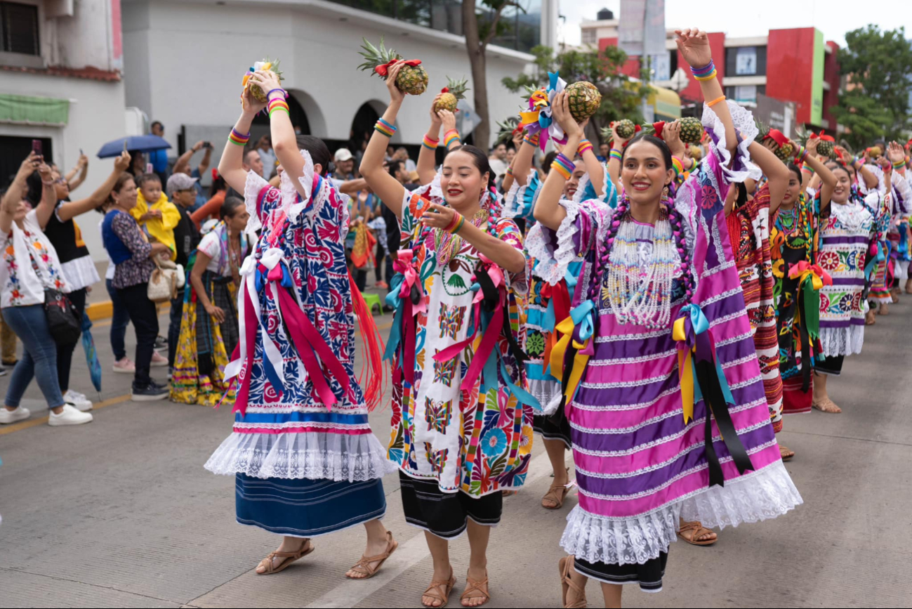 Las mujeres visten coloridos trajes con una pieza principal, una piña Las mujeres visten coloridos trajes con una pieza principal, una piña