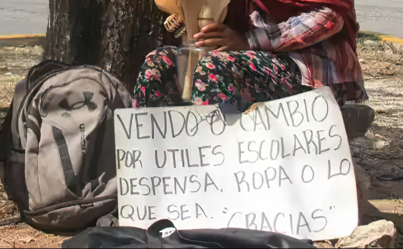 La pequeña sostiene un cartel con la esperanza de vender los utensilios