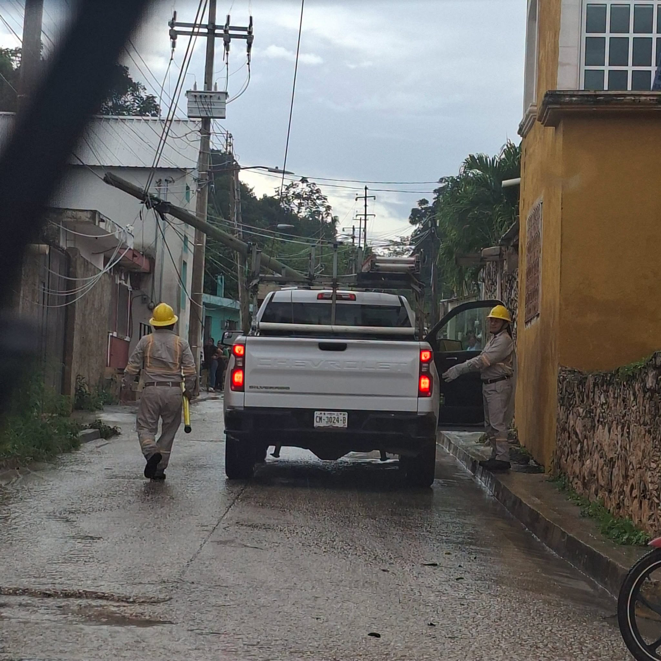 Un poste de luz cayó sobre cables eléctricos en el centro de Hopelchén tras las recientes lluvias.