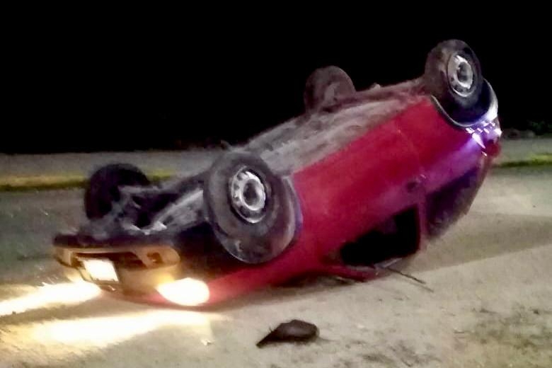Auto volcado por exceso de velocidad 
