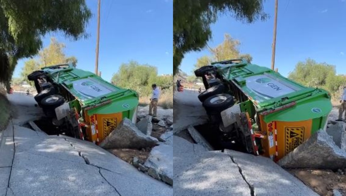 El socavó provocó que el camión de basura se volcara El socavó provocó que el camión de basura se volcara